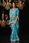 Sky blue tissue silk saree with intricate zari and sequin embroidery.