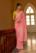 Salmon colored nylon silk saree with intricate gold zari weaving patterns