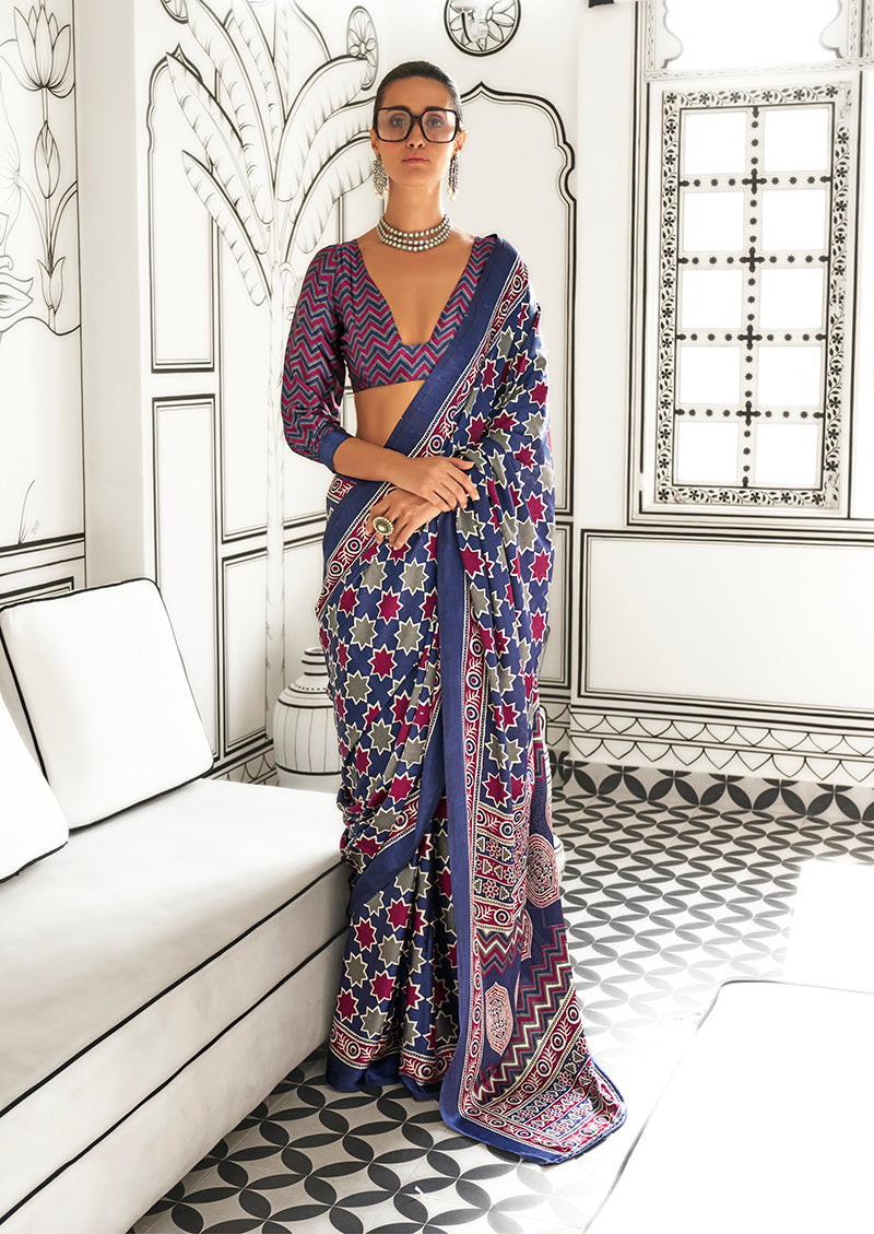 Navy blue satin crepe saree with abstract print, perfect for formal occasions.