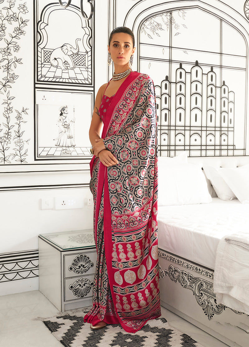 A glamorous black and maroon printed satin crepe saree with an abstract design.