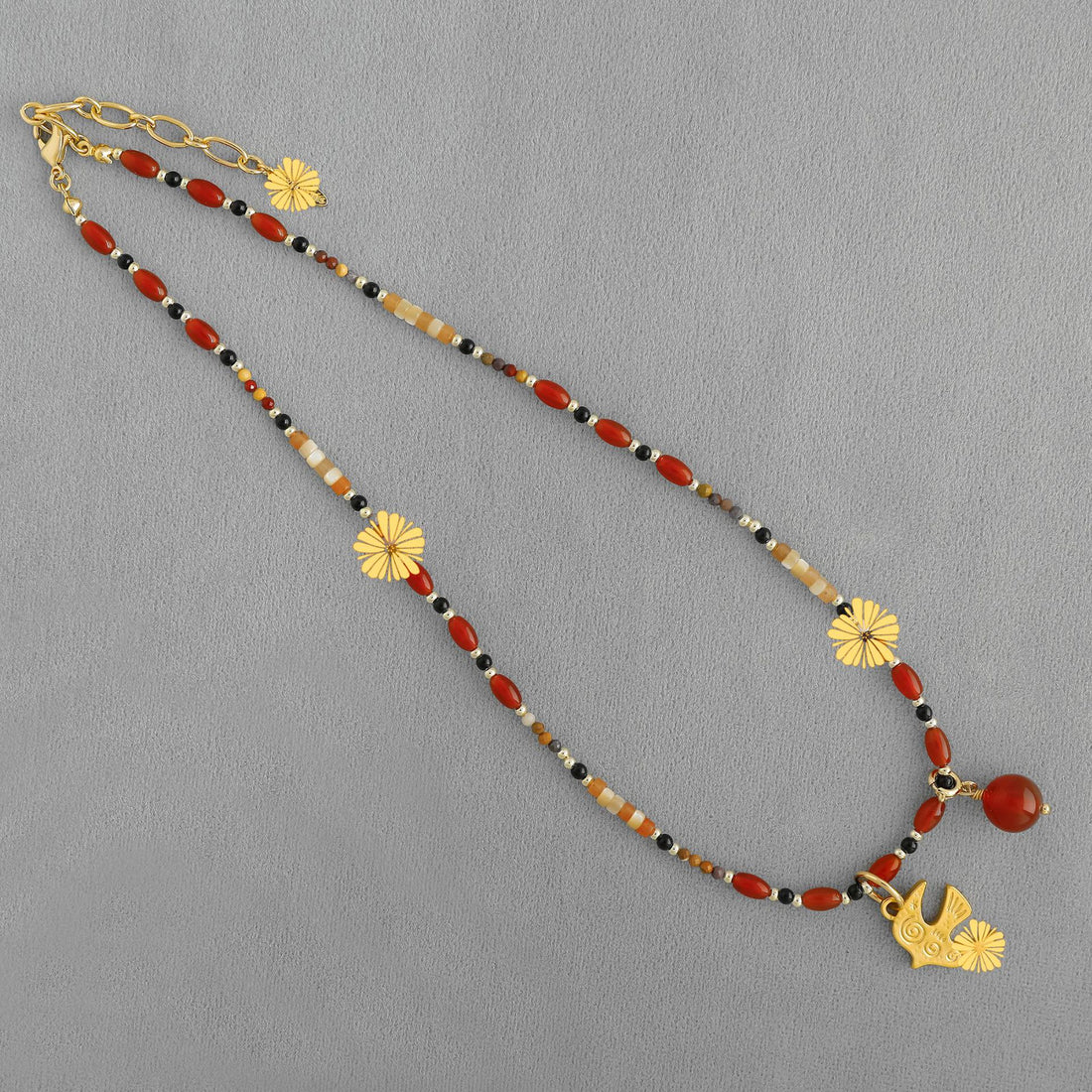 Handmade brass bird pendant necklace with red agate stone accents
