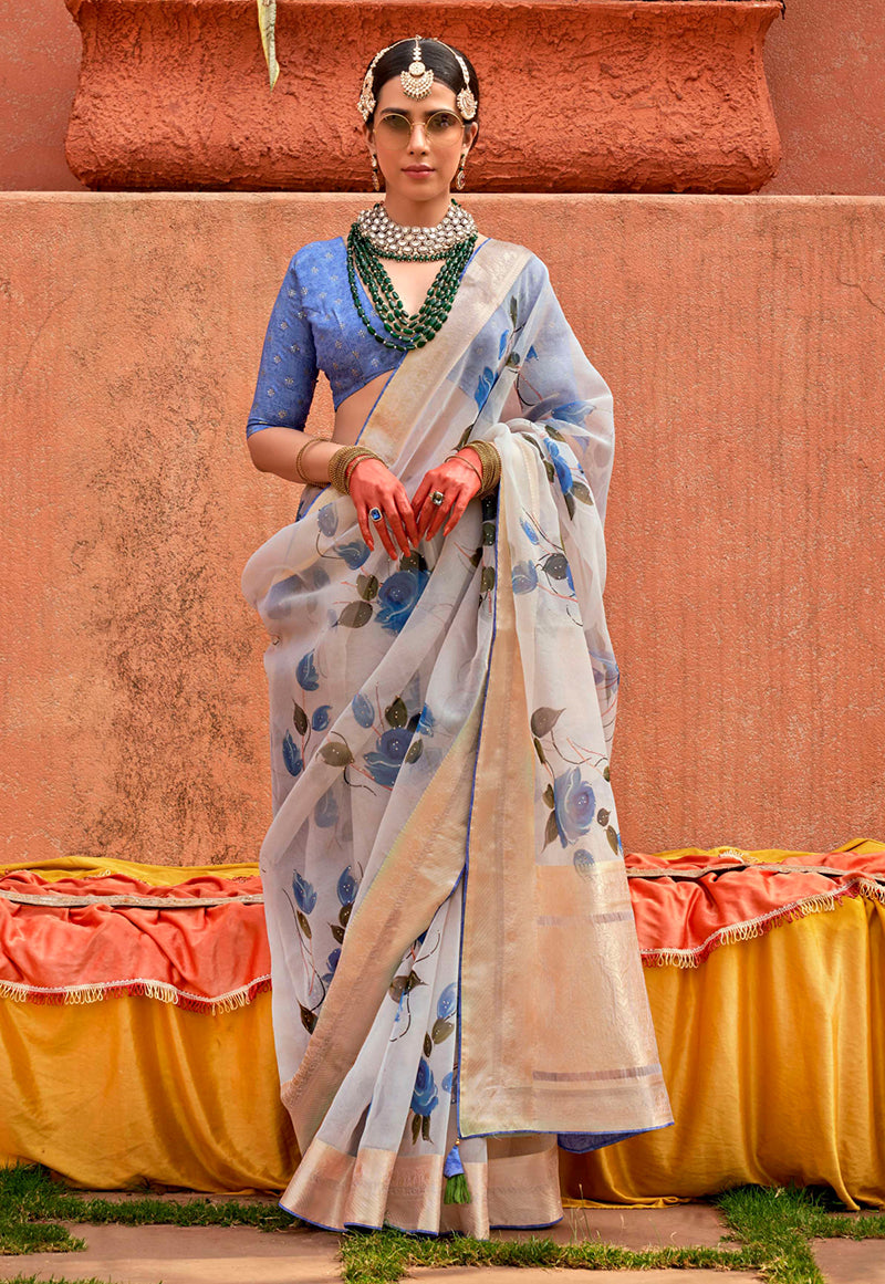 A stylish aqua blue organza saree with a contemporary print, perfect for modern festive wear.