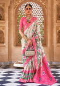 Elegant white Banarasi silk saree with refined woven patterns.