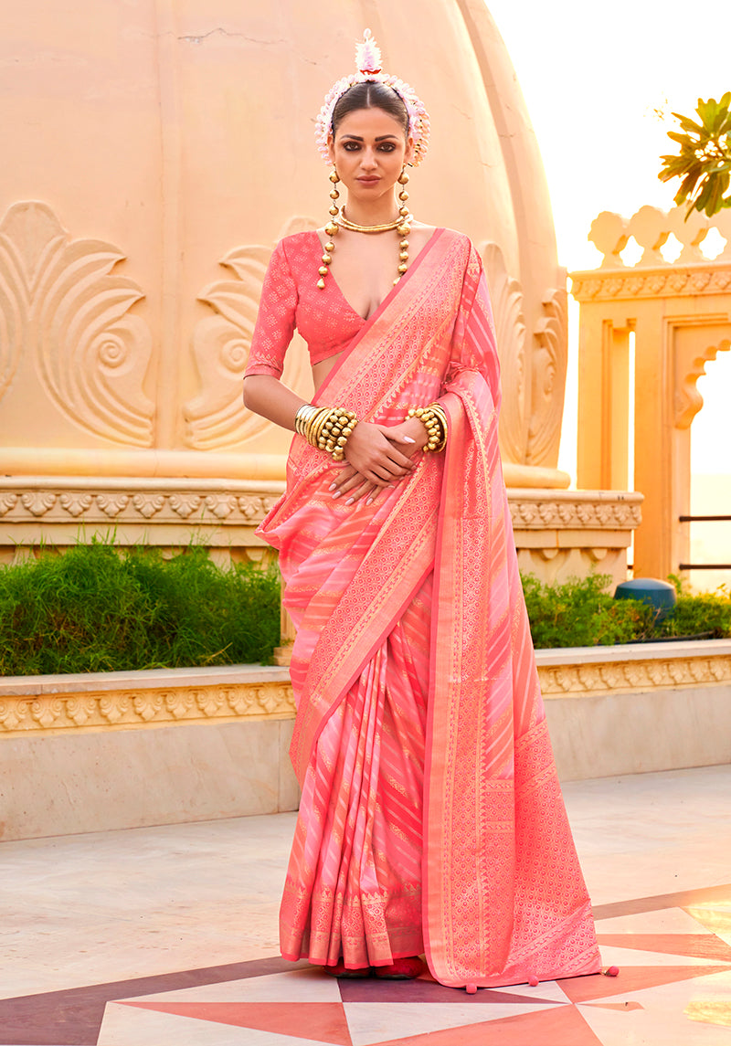 Peach silk saree decorated with shimmering ethnic foil prints, perfect for ceremonies.