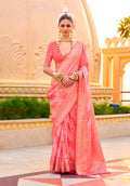 Peach silk saree decorated with shimmering ethnic foil prints, perfect for ceremonies.