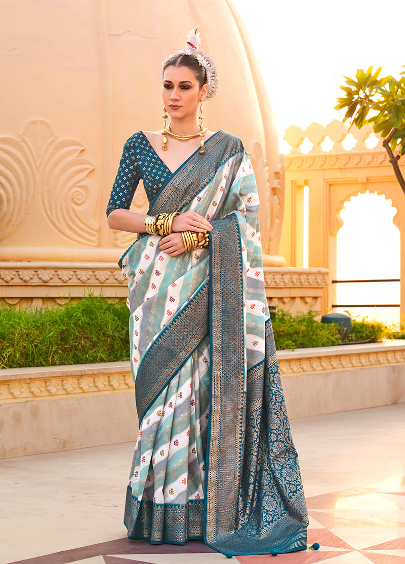 Vibrant teal silk saree featuring intricate metallic foil print details