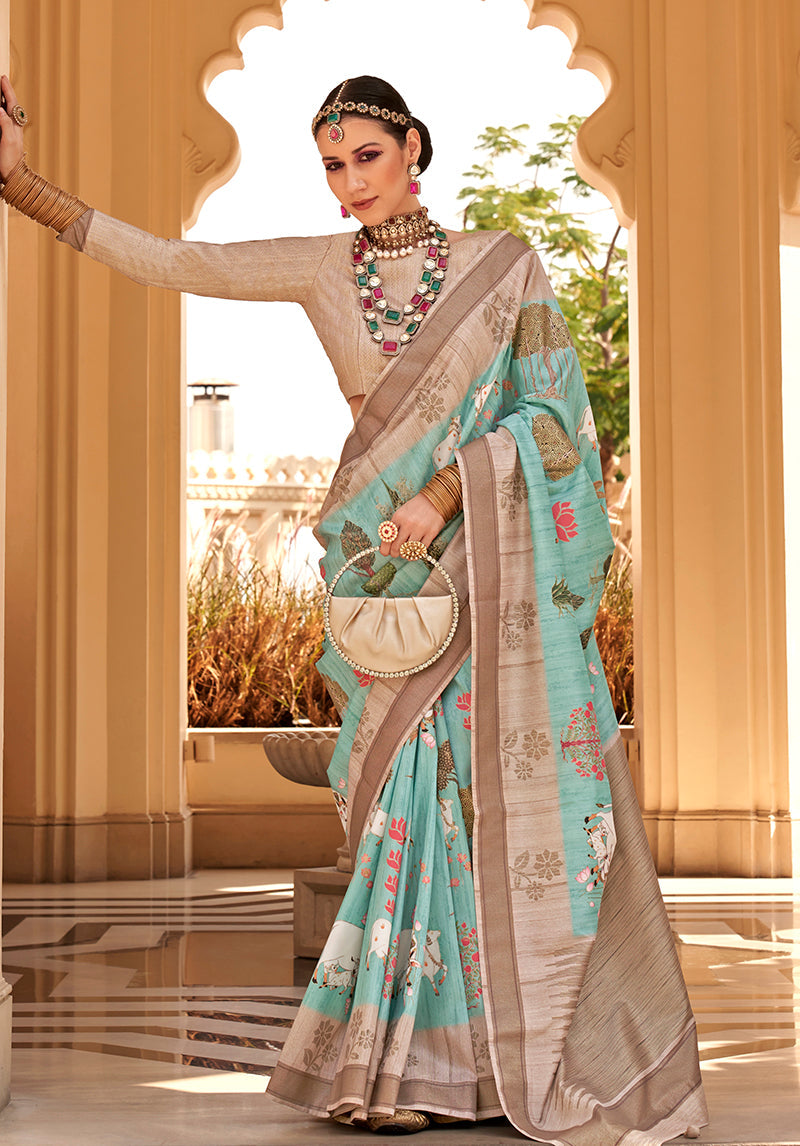 Turquoise raw silk saree with elegant foliage pattern