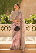 Light pink raw silk saree draped elegantly with foil print accents