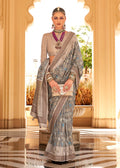 A trendy multi-color raw silk saree featuring shimmering foil print patterns, ideal for evening wear.