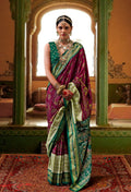 Burgundy silk saree featuring a traditional Patola print and elegant aesthetic.