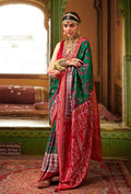 Elegant green silk saree with traditional Patola print patterns