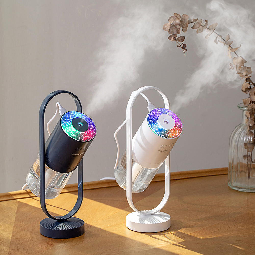 Modern Magic Shadow USB humidifier in white with RGB projection light on a minimalist office desk.