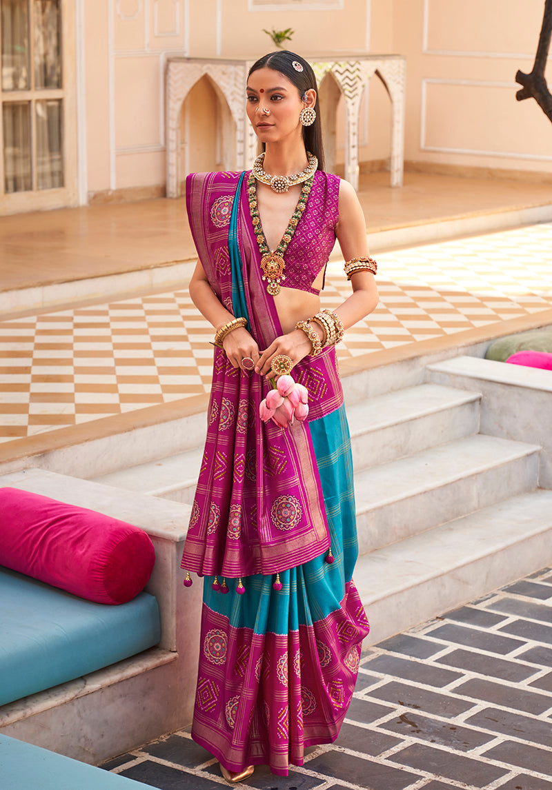 Magenta silk saree featuring foliage prints and traditional foil accents