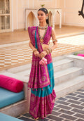 Magenta silk saree featuring foliage prints and traditional foil accents