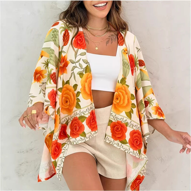 A woman wearing a vibrant floral print open-front cardigan with drop shoulder sleeves and a relaxed mid-length fit.