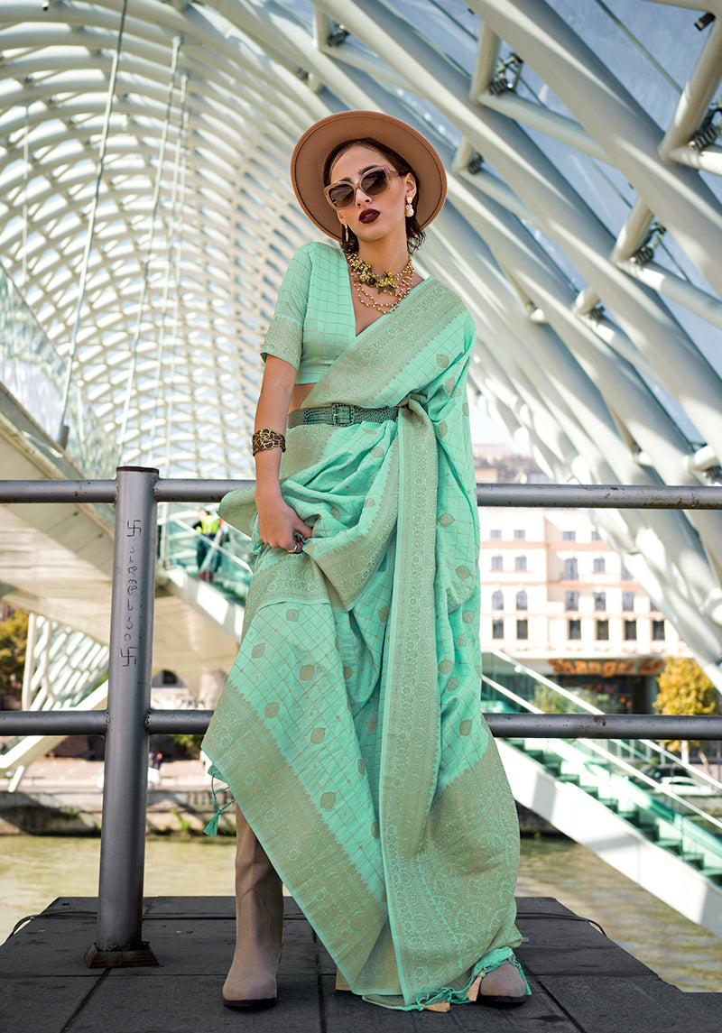 A stunning light cyan katan silk saree with elegant zari embroidery throughout.