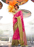A luxurious rani pink katan silk saree with detailed traditional weaving.