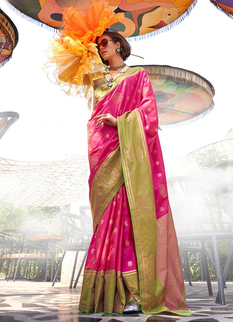 A luxurious rani pink katan silk saree with detailed traditional weaving.