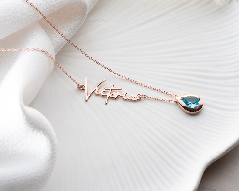 Personalized cursive name necklace with a custom birthstone charm on a minimalist chain