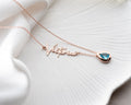 Personalized cursive name necklace with a custom birthstone charm on a minimalist chain