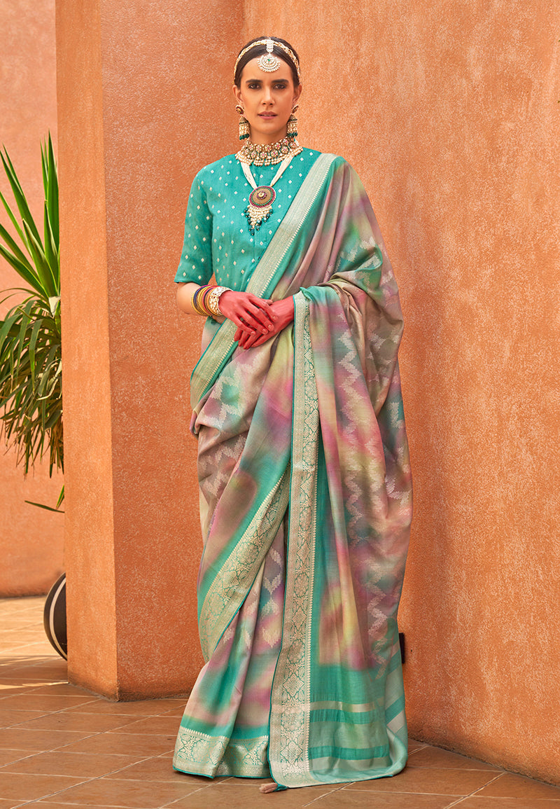 Turquoise silk saree featuring detailed foliage foil prints