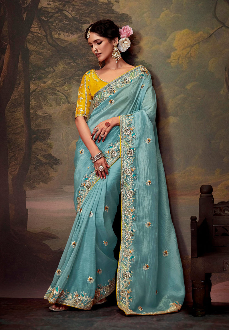 Aqua blue organza saree featuring intricate embroidered thread work.