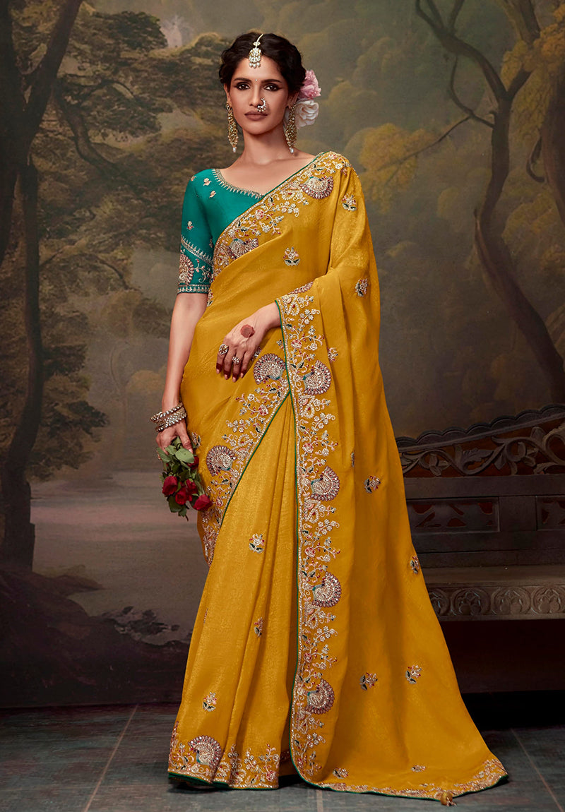 Mustard organza saree with intricate thread work embroidery and elegant drape.