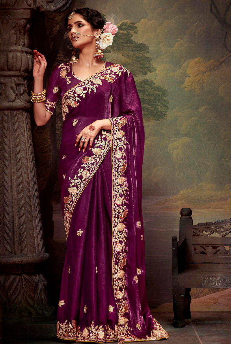 Deep burgundy organza saree with traditional thread work embroidery.