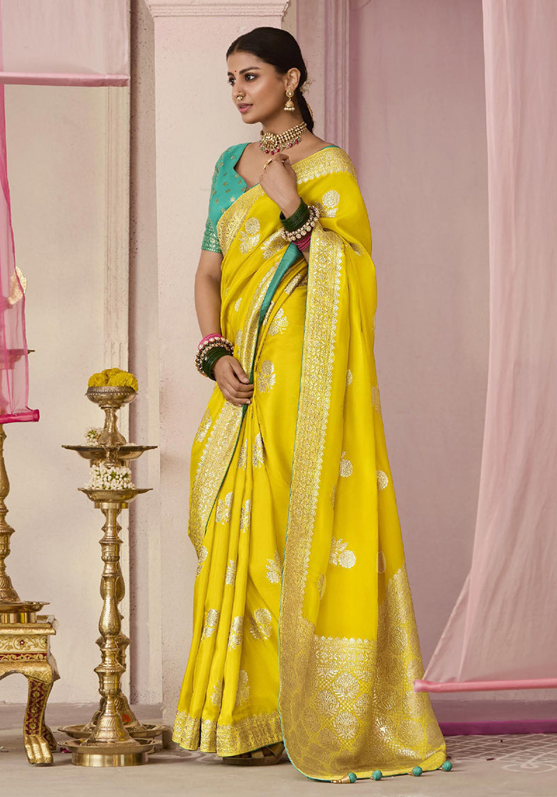 Yellow viscose saree with floral prints and traditional weaving.