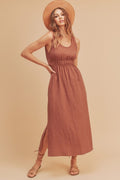 A versatile sleeveless round neck tank dress with a side slit