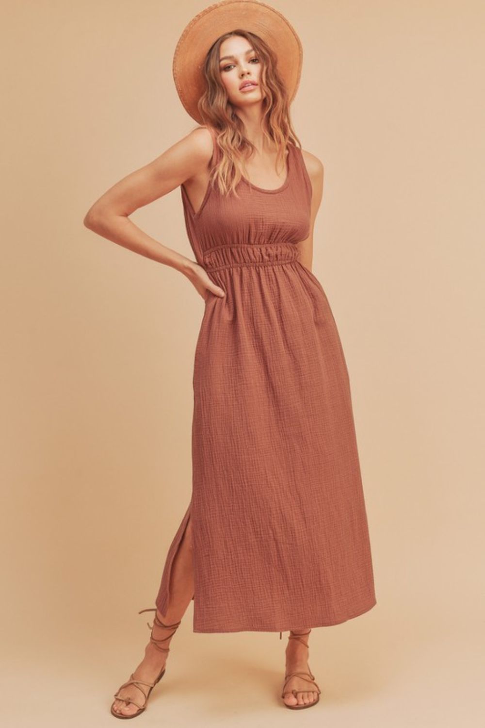 A versatile sleeveless round neck tank dress with a side slit