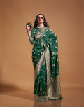 Dark green silk saree featuring intricate traditional woven designs