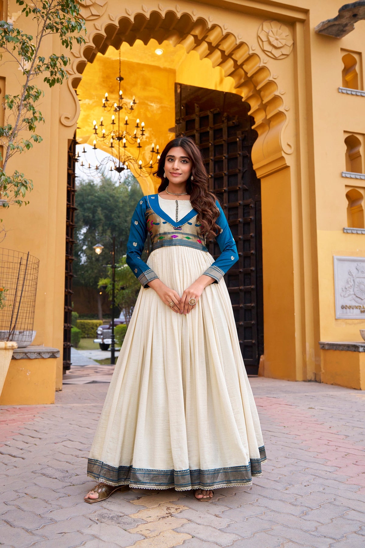 Off-white long dress crafted from Vichitra Silk with detailed Zari weaving
