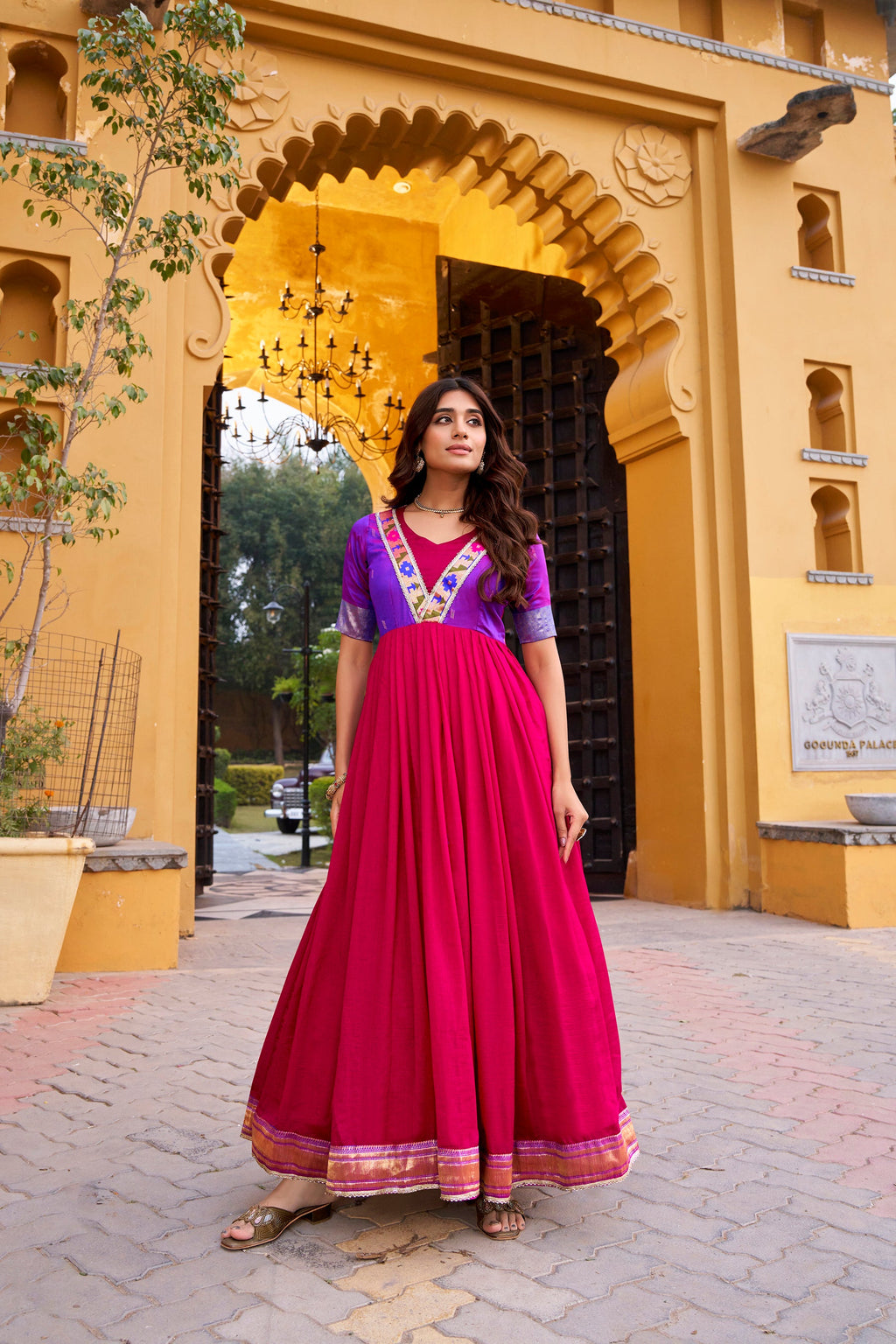Pink Vichitra silk long dress featuring intricate zari weaving and delicate lace trim.