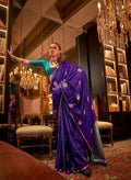 Woman wearing a vibrant teal satin traditional saree with intricate gold geometric weaving for a festive formal event.