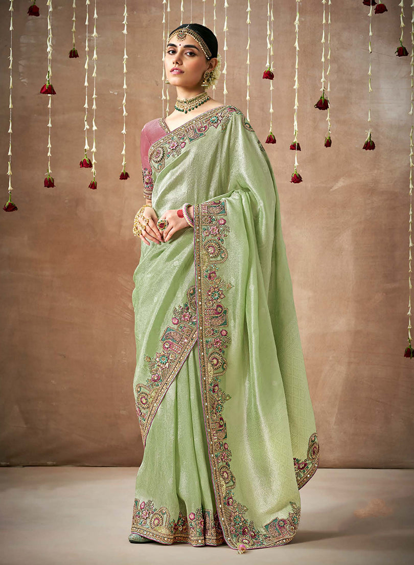 Sea green organza silk saree with detailed embroidery for festive occasions