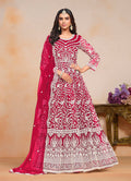 Rani-Pink embroidered net salwar suit featuring intricate thread work.