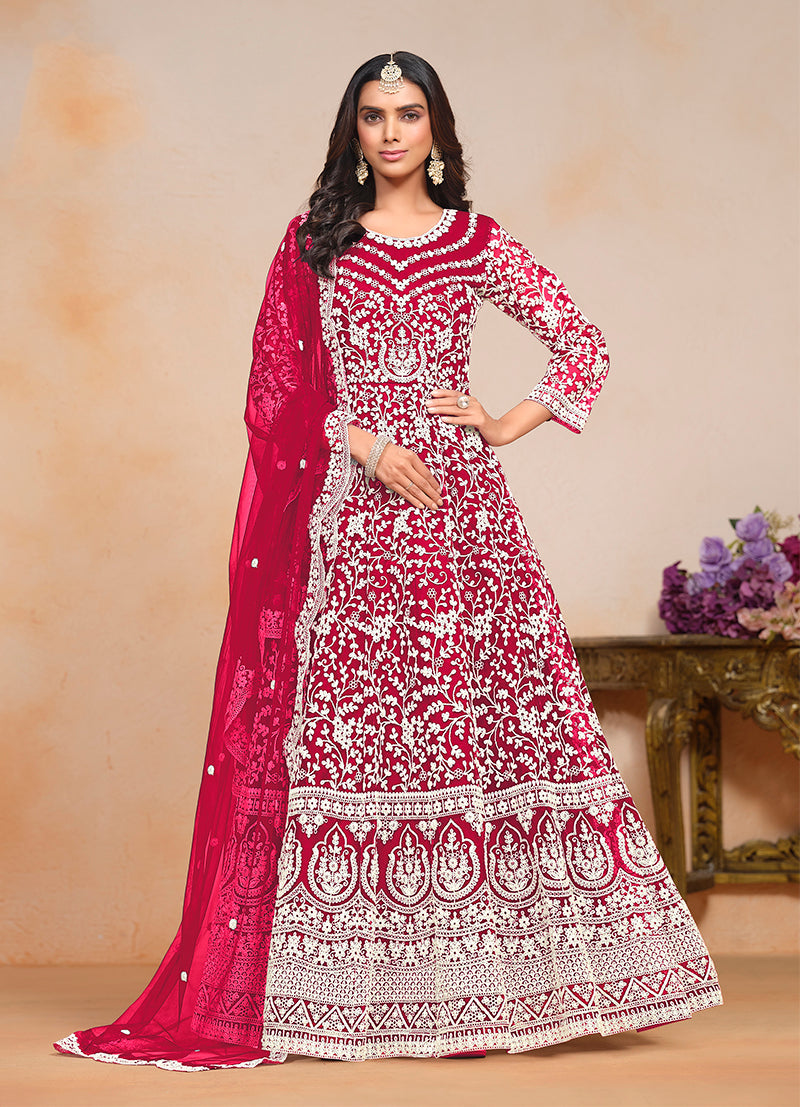 Rani-Pink embroidered net salwar suit featuring intricate thread work.