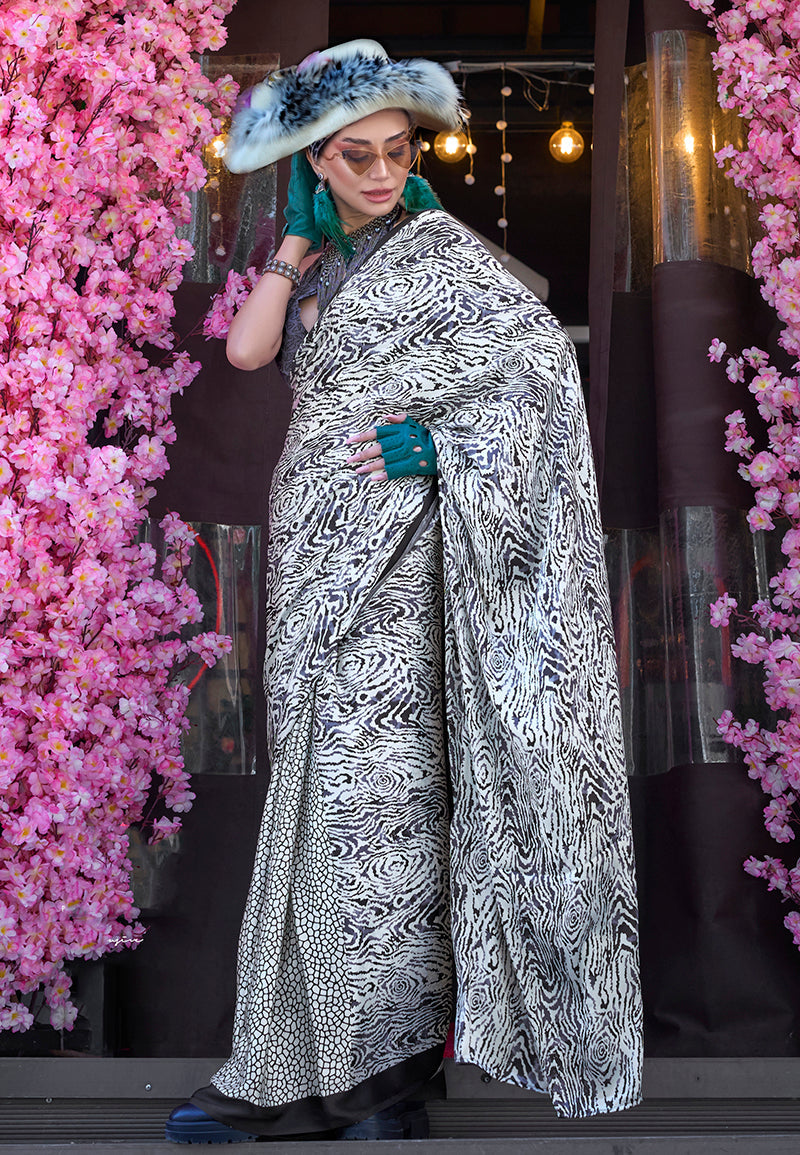 A classic white and black printed satin saree with a smooth finish.