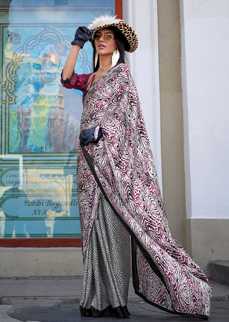 Close-up of a multi-colour printed satin saree showing vibrant patterns.