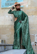 Dark green printed satin saree featuring elegant patterns