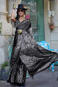 A beautiful black satin saree with delicate prints, styled for an elegant and classic look.