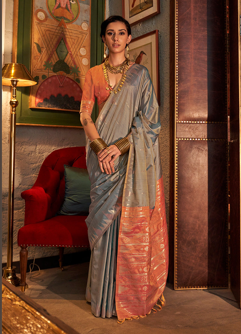 A traditional grey Tussar silk saree with elegant woven detailing.