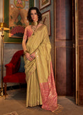 A traditional golden Tussar silk saree featuring elaborate woven patterns.