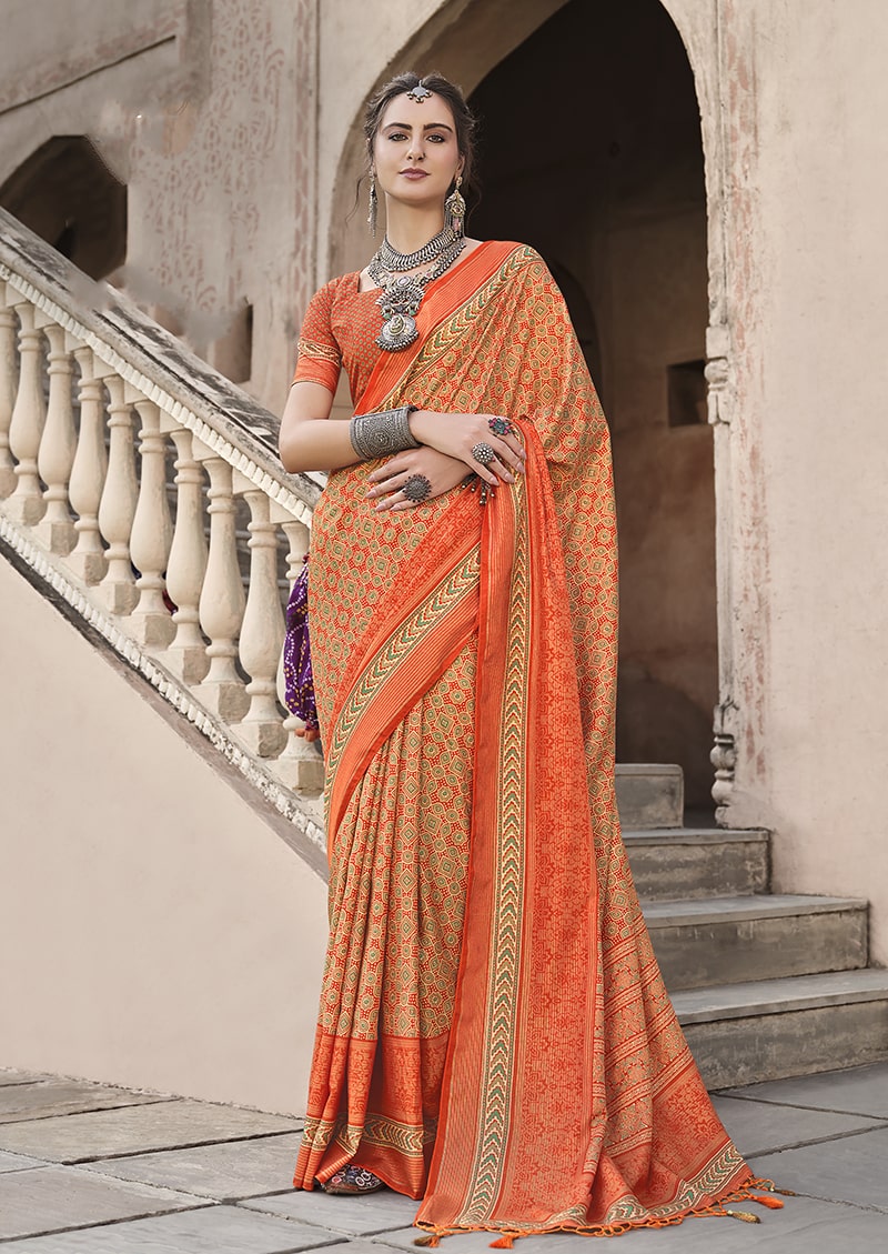 Vibrant orange silk saree decorated with traditional Patola print patterns