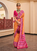 Mustard and rani pink Patola print silk saree with vibrant geometric designs