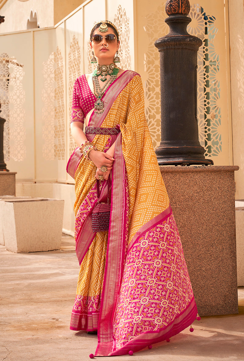 Yellow and rani pink Patola print saree with traditional geometric patterns