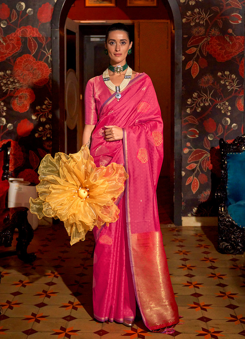 A beautiful pink handloom silk saree with intricate ethnic weaving patterns.