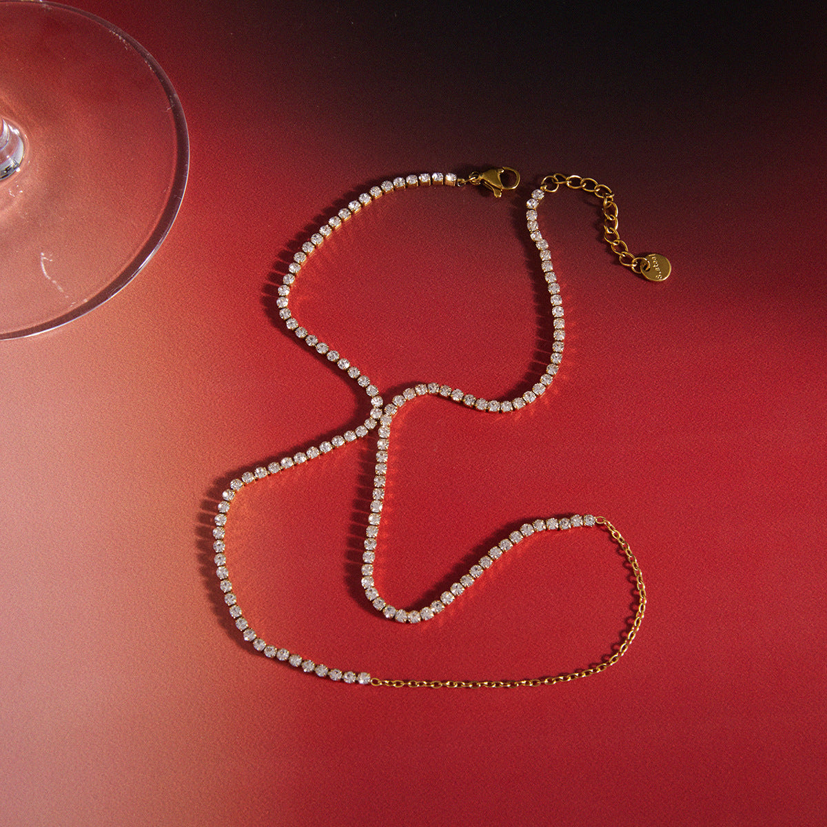 Gold hand chain and ring bracelet set adorned with clear rhinestones