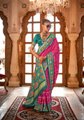 Rani pink contemporary silk saree featuring intricate traditional Patola prints.